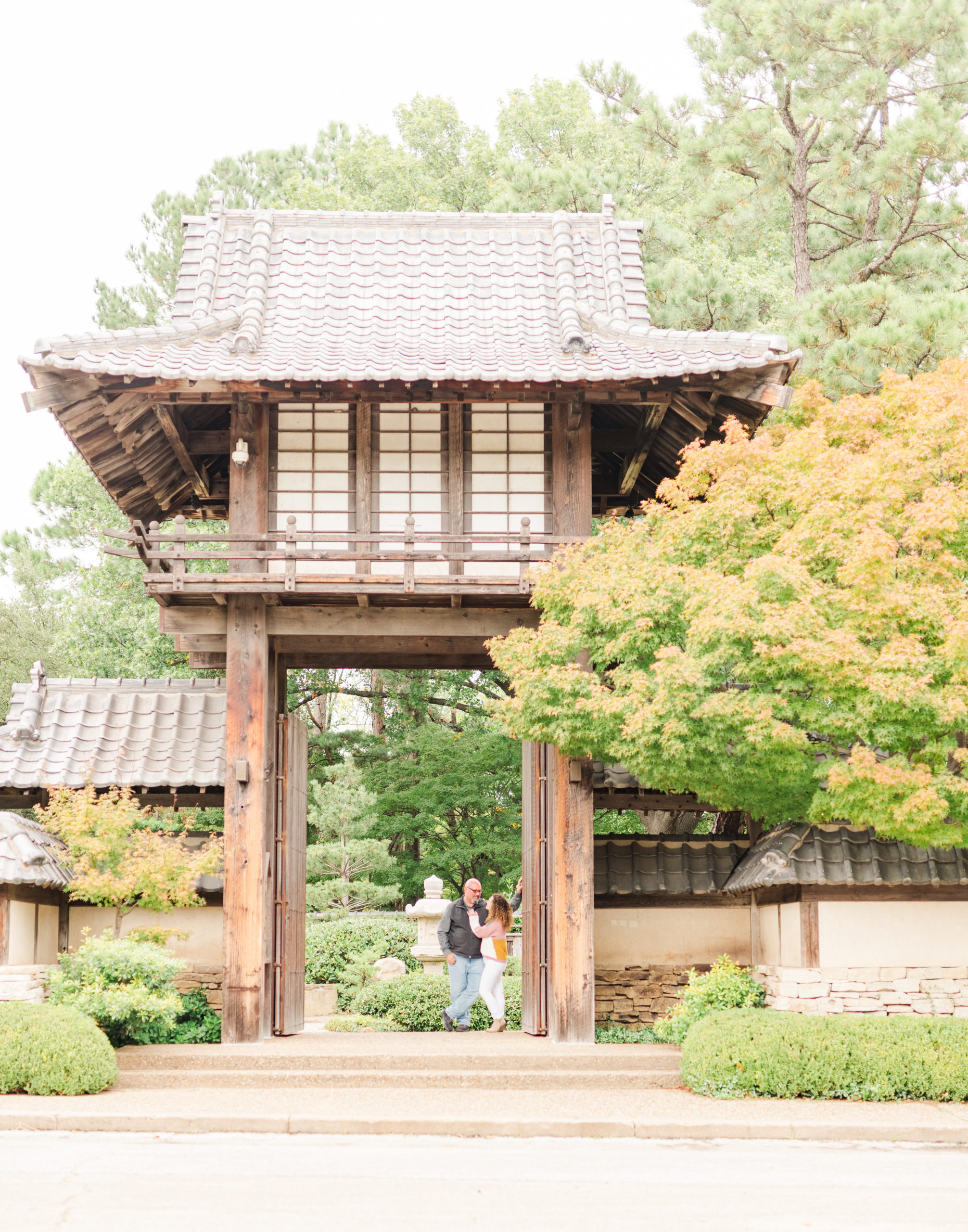 Couple under doorway at the Japanese Garden, Fort Worth Texas during engagement session